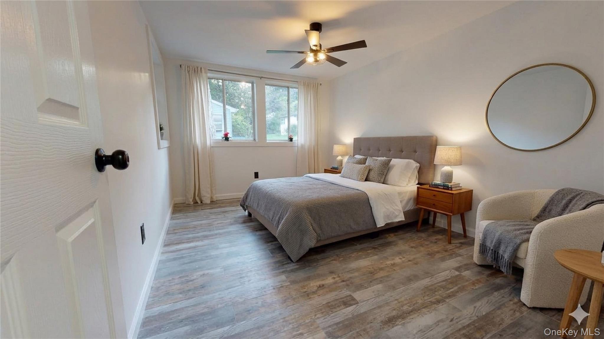 191 Sylvan Lake Road, Unit 30 Hopewell Junction, NY 12533 - Photo 18 of 37 a bedroom with bed and a chandelier