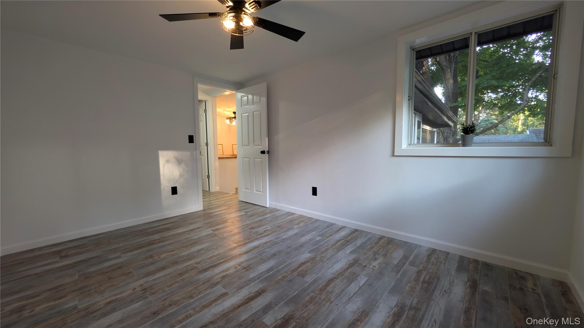 191 Sylvan Lake Road, Unit 30 Hopewell Junction, NY 12533 - Photo 19 of 34 a view of an empty room with wooden floor and window