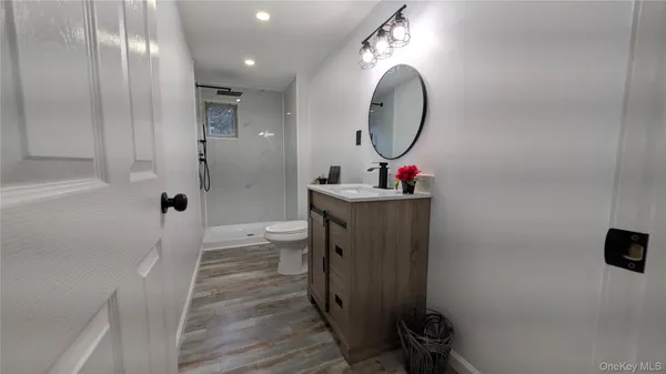 a room with a mirror and a wooden floor