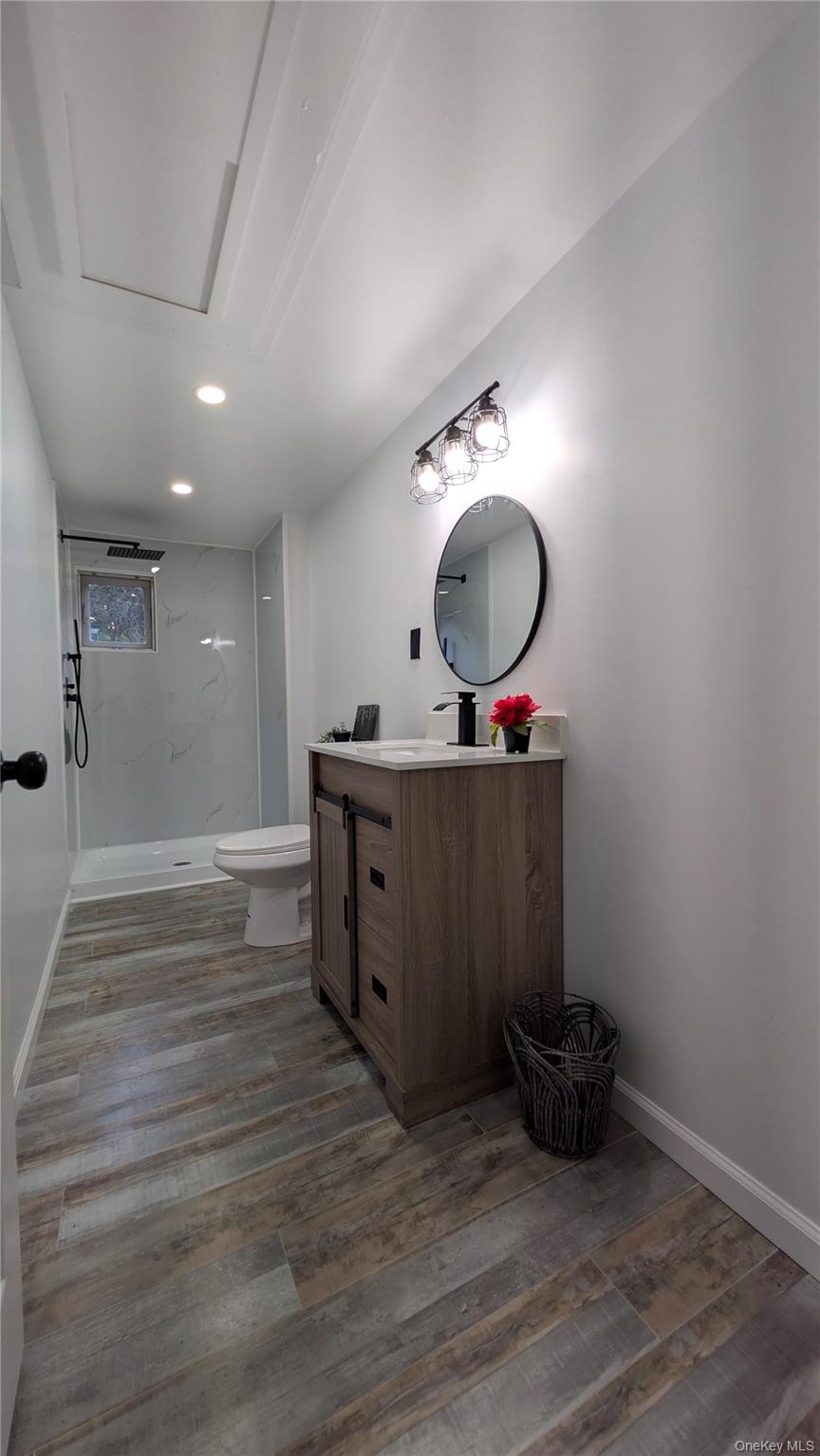191 Sylvan Lake Road, Unit 30 Hopewell Junction, NY 12533 - Photo 23 of 37 a room with a mirror and a wooden floor