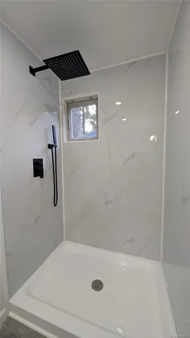 a bathroom with a toilet and a mirror