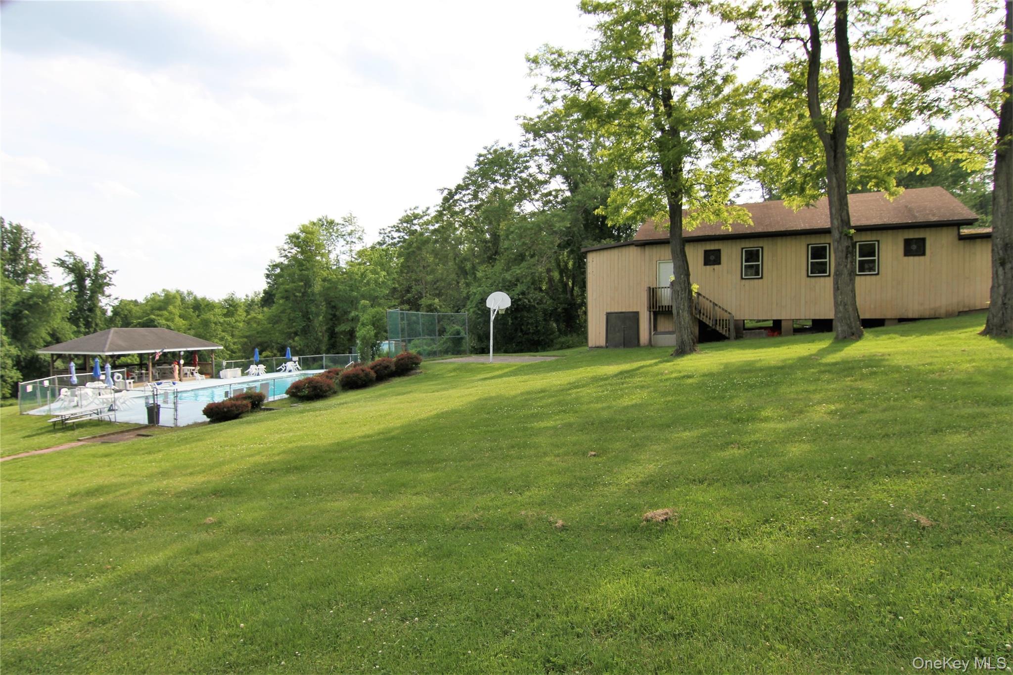 191 Sylvan Lake Road, Unit 30 Hopewell Junction, NY 12533 - Photo 32 of 34 a view of a house with a big yard and large trees