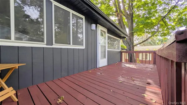 a view of backyard with deck and wooden floor