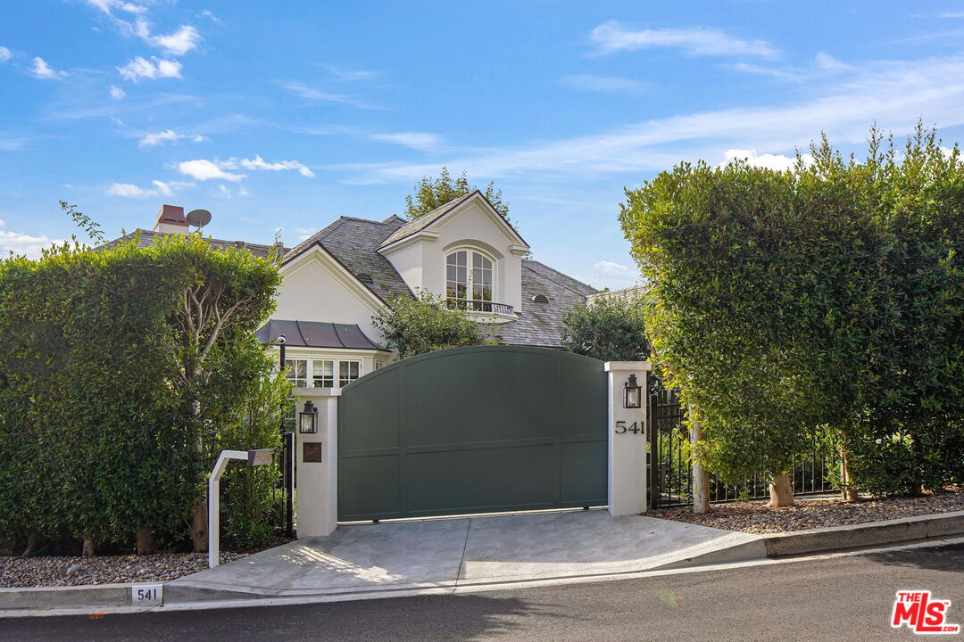 541 Paseo Miramar Pacific Palisades, CA 90272 - Photo 2 of 50 a front view of a house with a garden