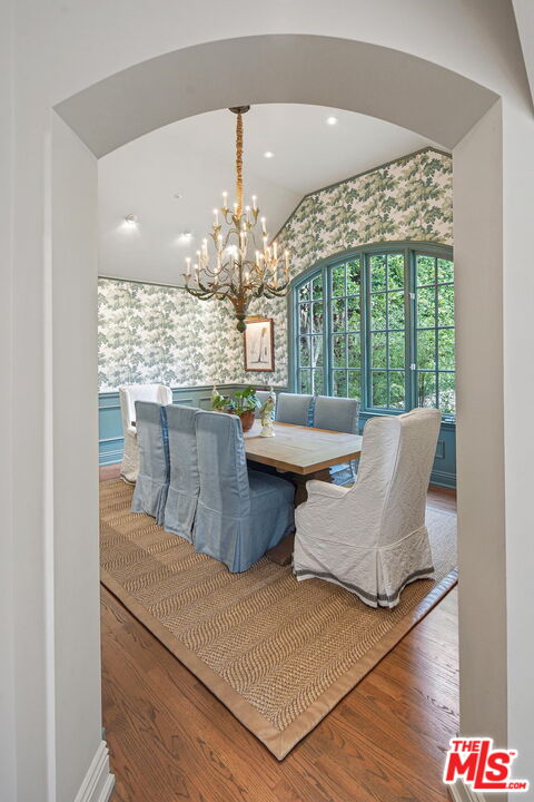 541 Paseo Miramar Pacific Palisades, CA 90272 - Photo 14 of 50 a view of a dining room with furniture a chandelier and wooden floor
