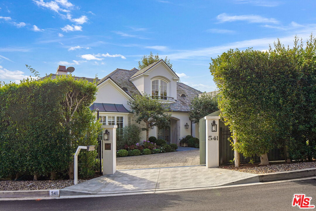 541 Paseo Miramar Pacific Palisades, CA 90272 - Photo 3 of 50 a front view of a house with a garden