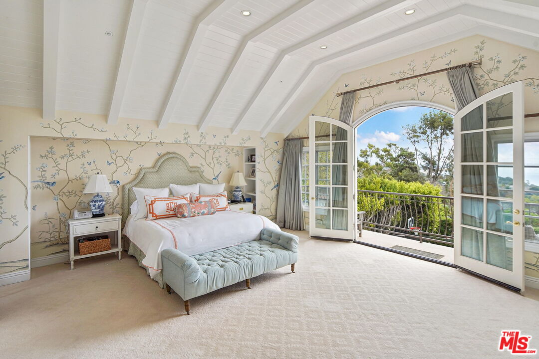541 Paseo Miramar Pacific Palisades, CA 90272 - Photo 25 of 50 a bedroom with a bed and glass door