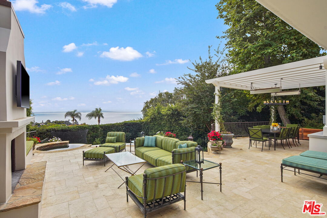 541 Paseo Miramar Pacific Palisades, CA 90272 - Photo 38 of 50 a balcony with wooden floor table and chairs