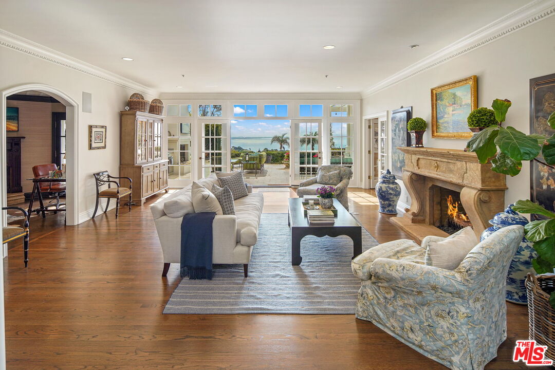 541 Paseo Miramar Pacific Palisades, CA 90272 - Photo 7 of 50 a living room with fireplace furniture and a large window
