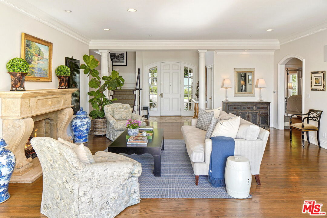 541 Paseo Miramar Pacific Palisades, CA 90272 - Photo 10 of 50 a living room with fireplace furniture and a wooden floor