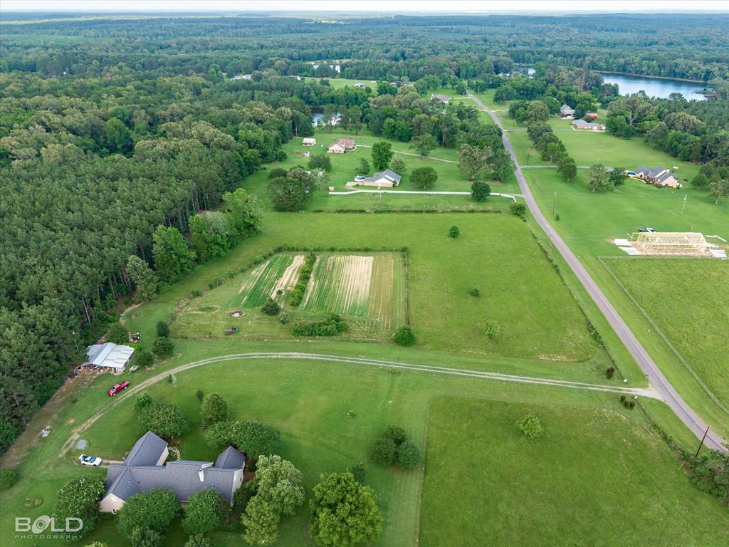 0 Twin Lakes Road Mansfield, LA 71052 - Photo 12 of 28 Expansive property featuring a large residence, cultivated fields, mature trees, and a private driveway