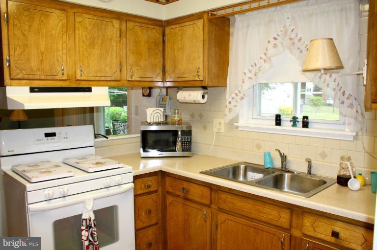 3711 Red Grove Road Baltimore, MD 21220 - Photo 14 of 24 a kitchen with a stove and a white cabinets