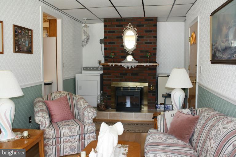 3711 Red Grove Road Baltimore, MD 21220 - Photo 17 of 24 a living room with furniture and a fireplace