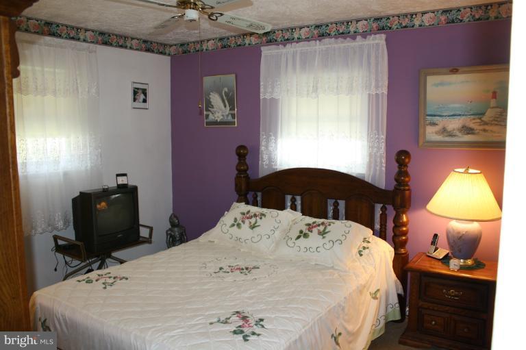 3711 Red Grove Road Baltimore, MD 21220 - Photo 10 of 24 a bed sitting in a bedroom next to a window
