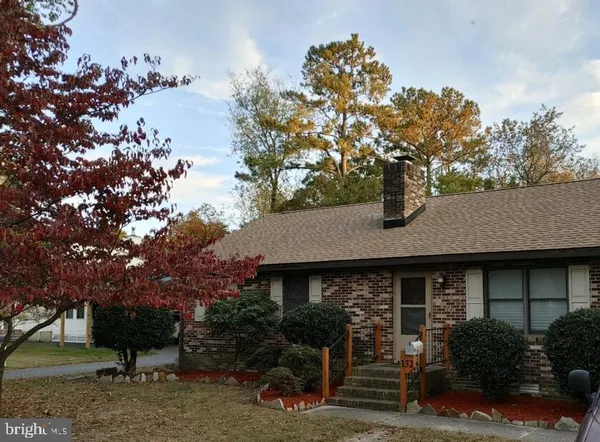 a view of house with outdoor space and trees