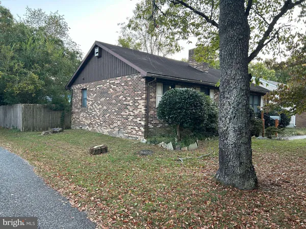 a view of a house with a yard and tree
