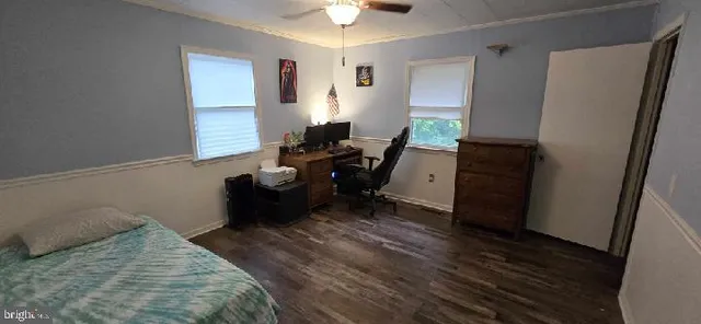 a bedroom with furniture and a window