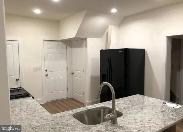 a kitchen with a refrigerator and a sink