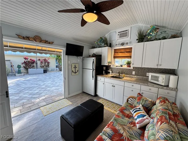 a kitchen with stainless steel appliances granite countertop a refrigerator and stove top oven