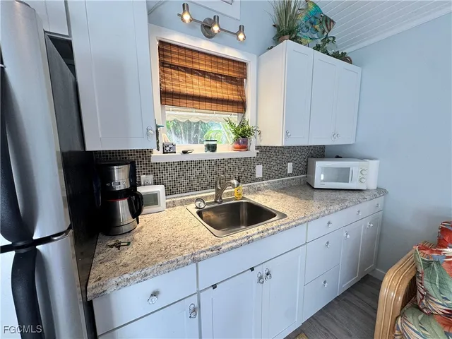 a kitchen with a sink cabinets and window