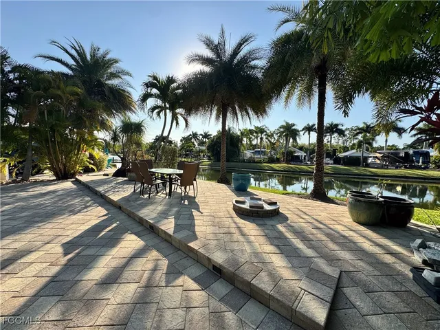 a view of a water fountain and a tree