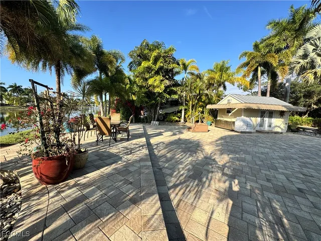 a view of a street with a building and trees