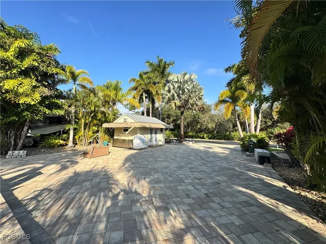 a backyard of a house with table and chairs
