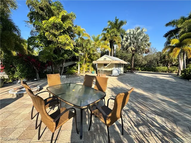 a view of a house with backyard and sitting area