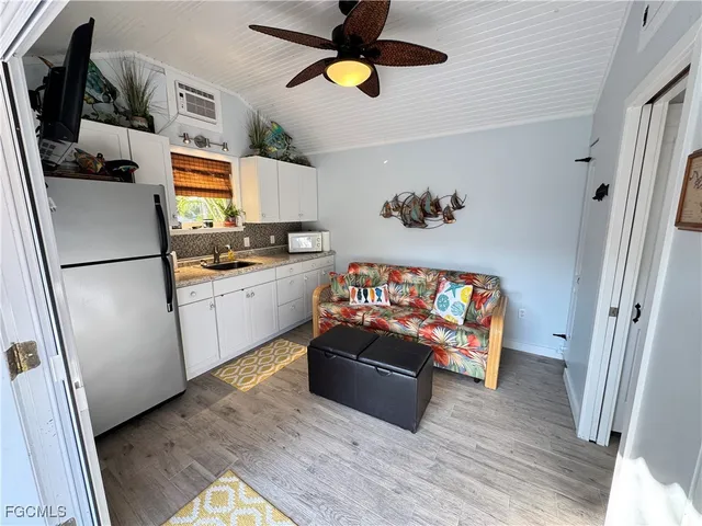 a kitchen with stainless steel appliances a stove a refrigerator and a microwave