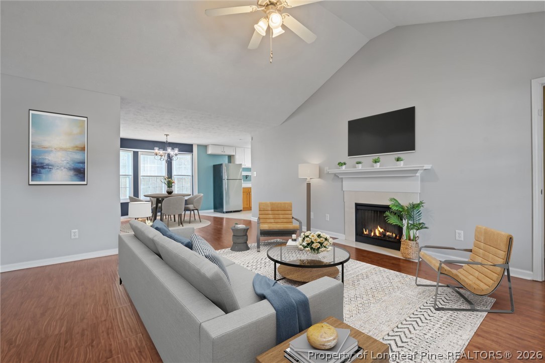 115 Shelby Street Spring Lake, NC 28390 - Photo 6 of 40 a living room with furniture a fireplace and a flat screen tv