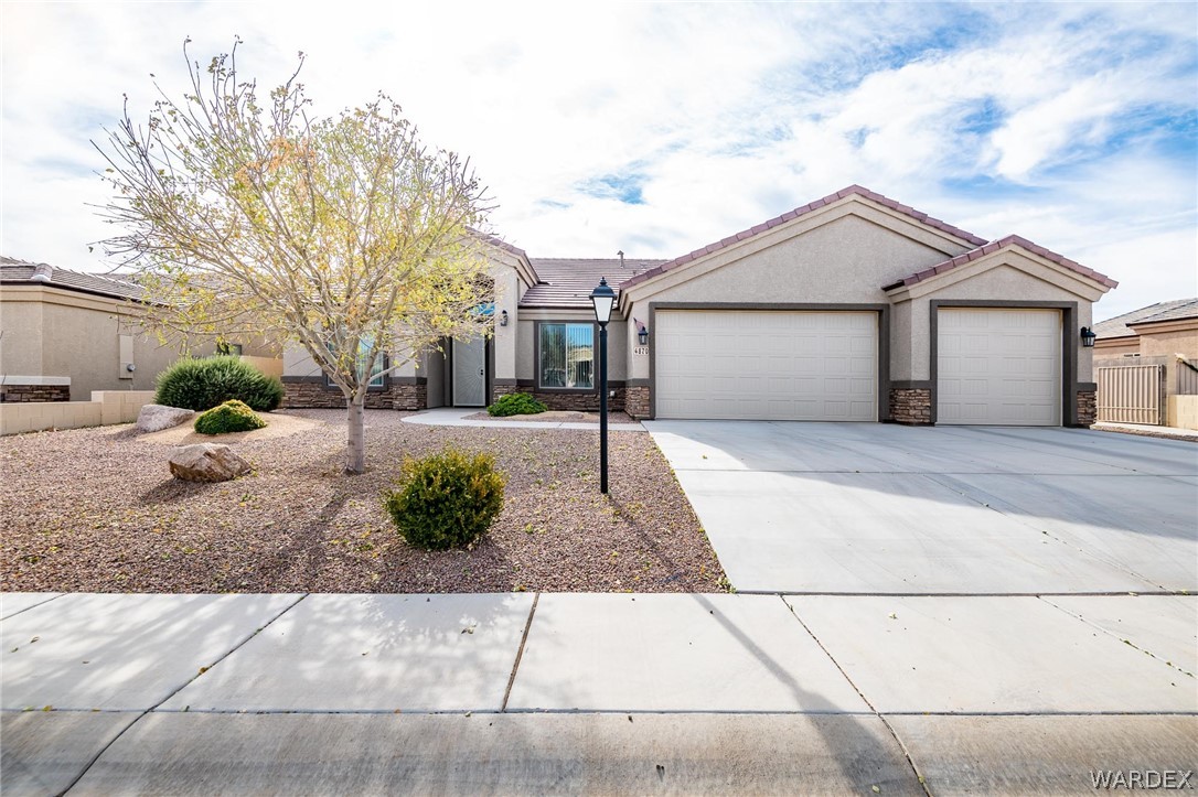 4870 North Old W Road Kingman, AZ 86401 - Photo 1 of 41 a front view of a house with a yard and garage