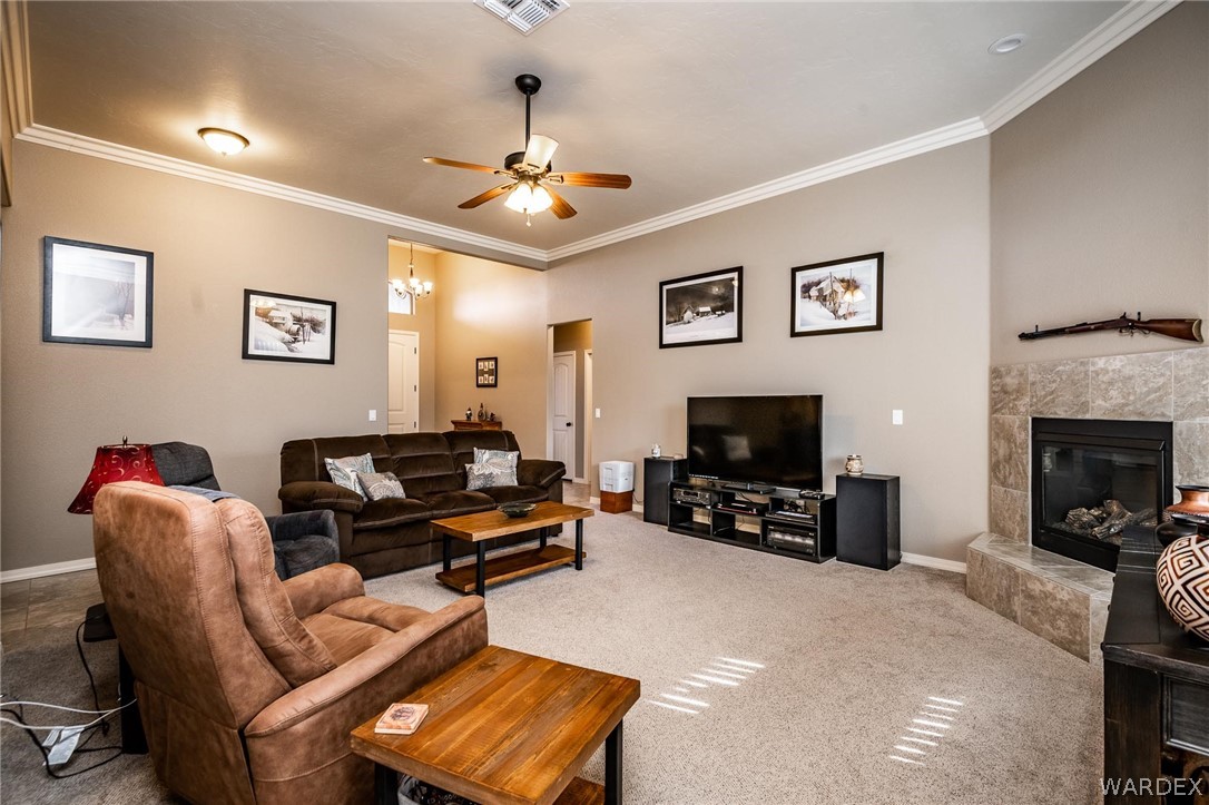4870 North Old W Road Kingman, AZ 86401 - Photo 13 of 41 a living room with furniture a flat screen tv and a fireplace