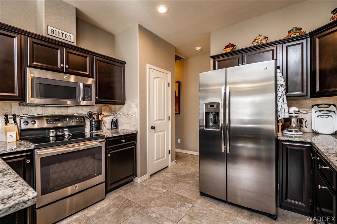 4870 North Old W Road Kingman, AZ 86401 - Photo 17 of 41 a modern kitchen with stainless steel appliances and refrigerator
