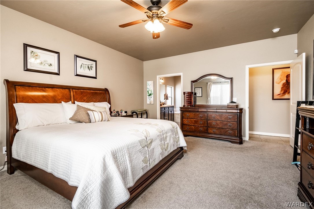4870 North Old W Road Kingman, AZ 86401 - Photo 21 of 41 a spacious bedroom with a bed and a chandelier