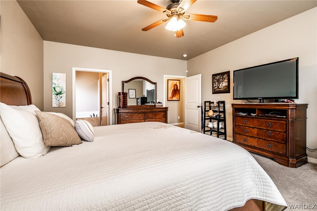 4870 North Old W Road Kingman, AZ 86401 - Photo 22 of 41 a bedroom with a bed and a flat screen tv
