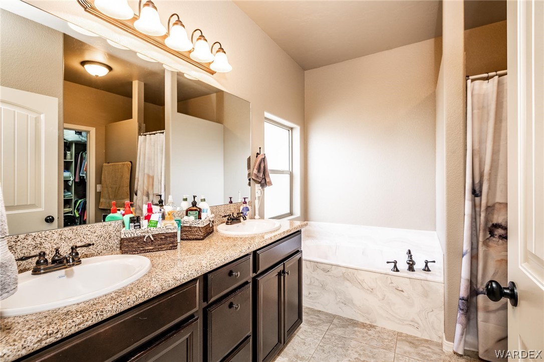 4870 North Old W Road Kingman, AZ 86401 - Photo 23 of 41 a bathroom with a granite countertop sink and a mirror