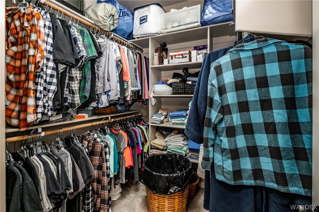 4870 North Old W Road Kingman, AZ 86401 - Photo 25 of 41 a view of walk in closet with clothes and shoes