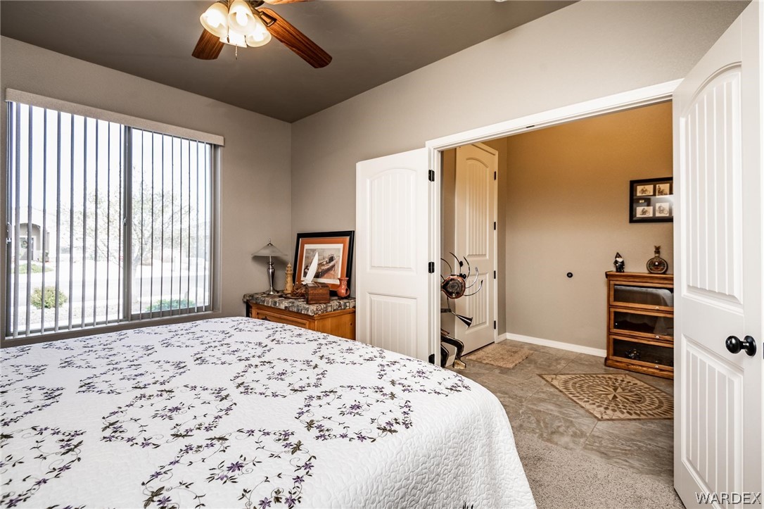4870 North Old W Road Kingman, AZ 86401 - Photo 26 of 41 a bedroom with a bed and a flat tv screen