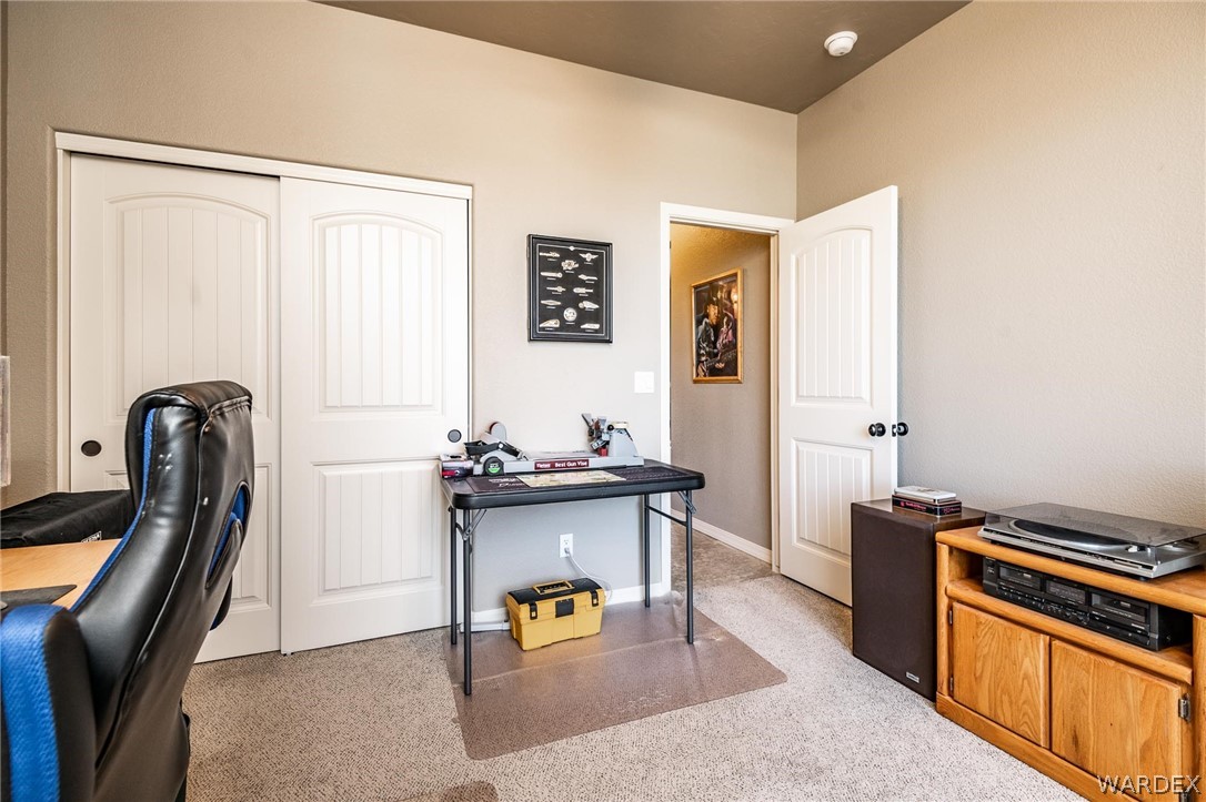 4870 North Old W Road Kingman, AZ 86401 - Photo 31 of 41 a kitchen with stainless steel appliances granite countertop a stove refrigerator and a dining table