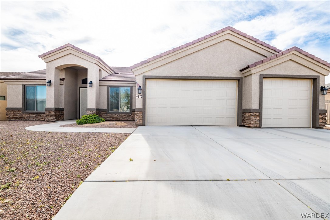 4870 North Old W Road Kingman, AZ 86401 - Photo 6 of 41 a front view of a house with a yard and garage