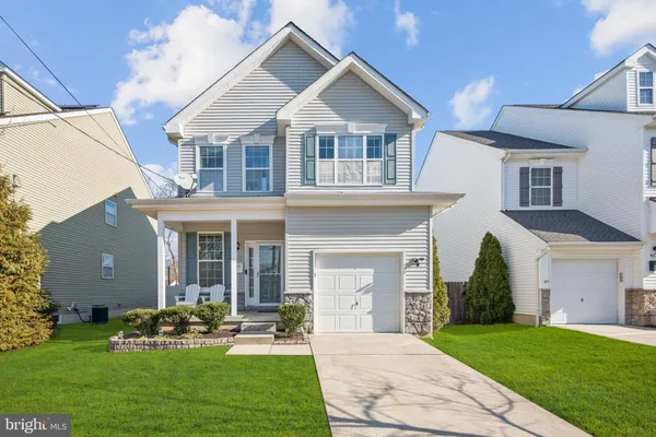 a front view of a house with a garden and plants