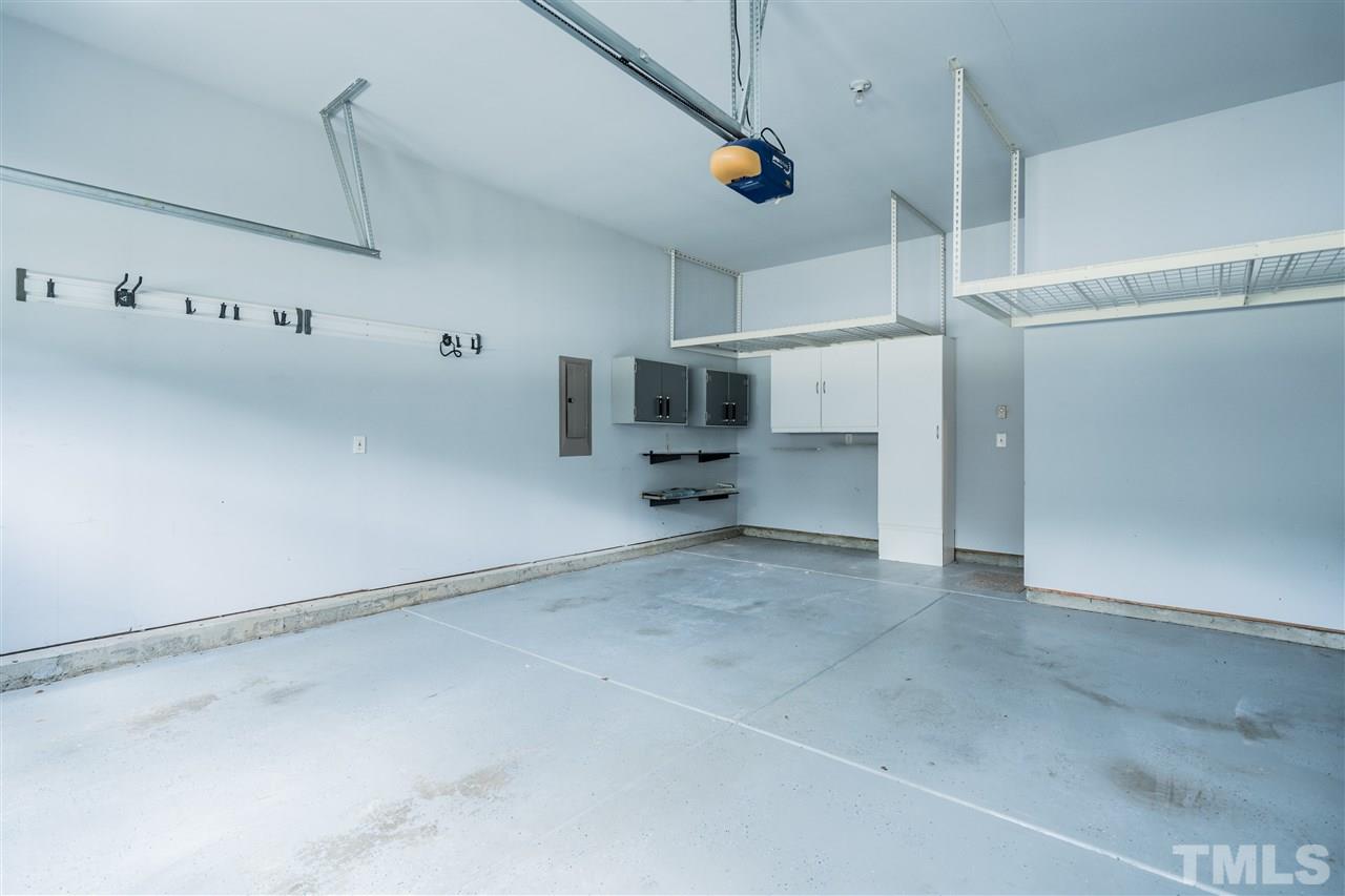 7775 Berry Crest Avenue Raleigh, NC 27617 - Photo 27 of 27 Two car garage has custom cabinets and overhead storage.