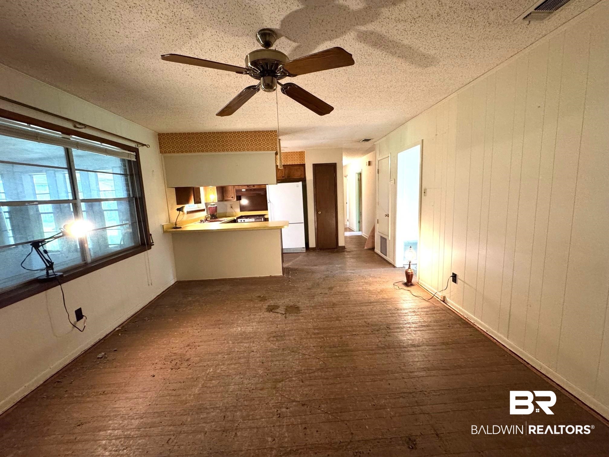 5198 Lancelot Drive Mobile, AL 36619 - Photo 9 of 30 Unfurnished living room with a textured ceiling, dark wood-style floors, and ceiling fan