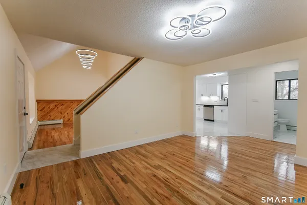 a view of empty room with wooden floor
