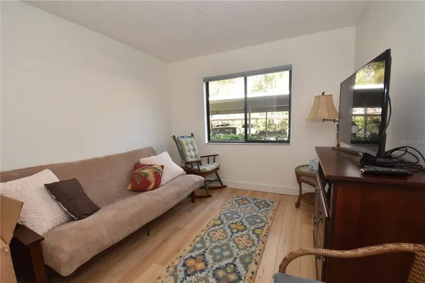 a living room with furniture lamp and window