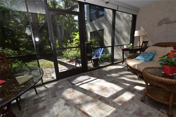 a living room with hardwood floor and a floor to ceiling window