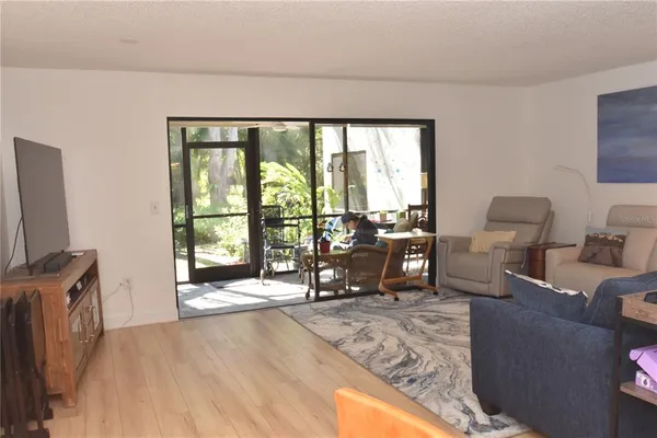 a living room with furniture and large windows