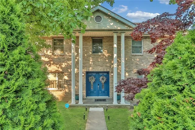 front view of a house with a garden