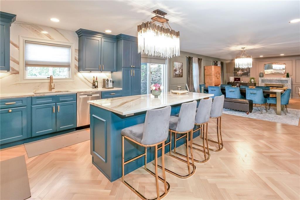 433 New Rochelle Road Bronxville, NY 10708 - Photo 11 of 41 a large kitchen with kitchen island a dining table and chairs