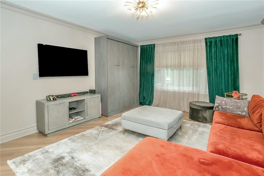 433 New Rochelle Road Bronxville, NY 10708 - Photo 17 of 41 a bedroom with two beds and a television